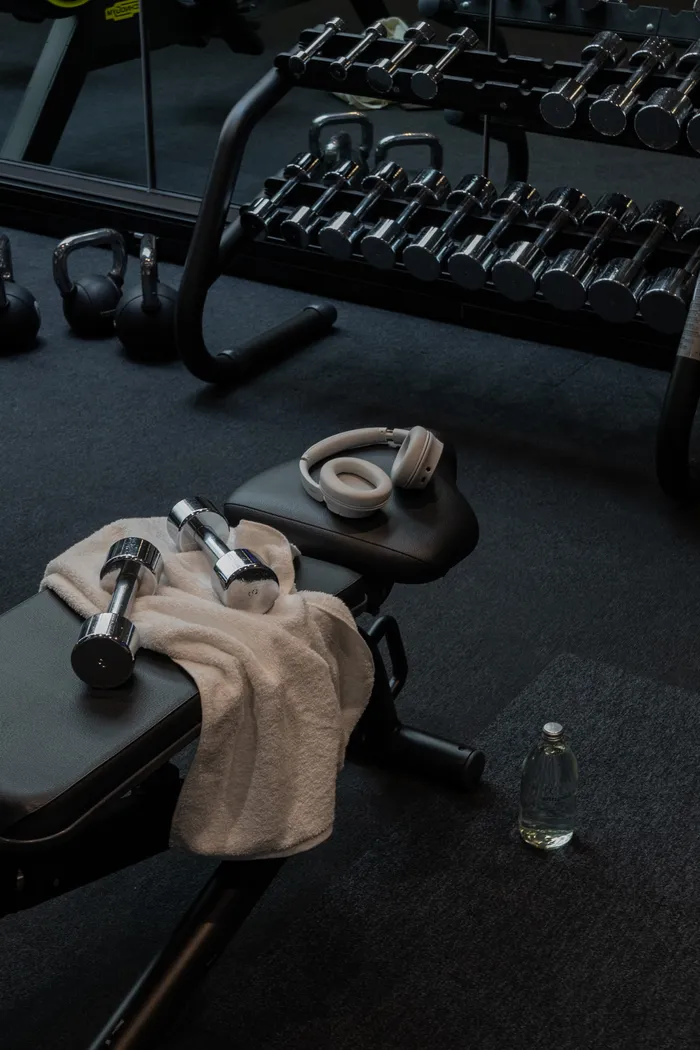 Premium gym equipment and accessories arranged on dark floor