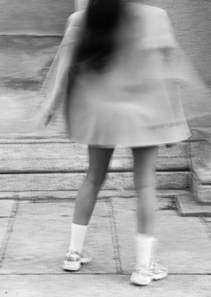 Woman in motion wearing white sneakers and socks
