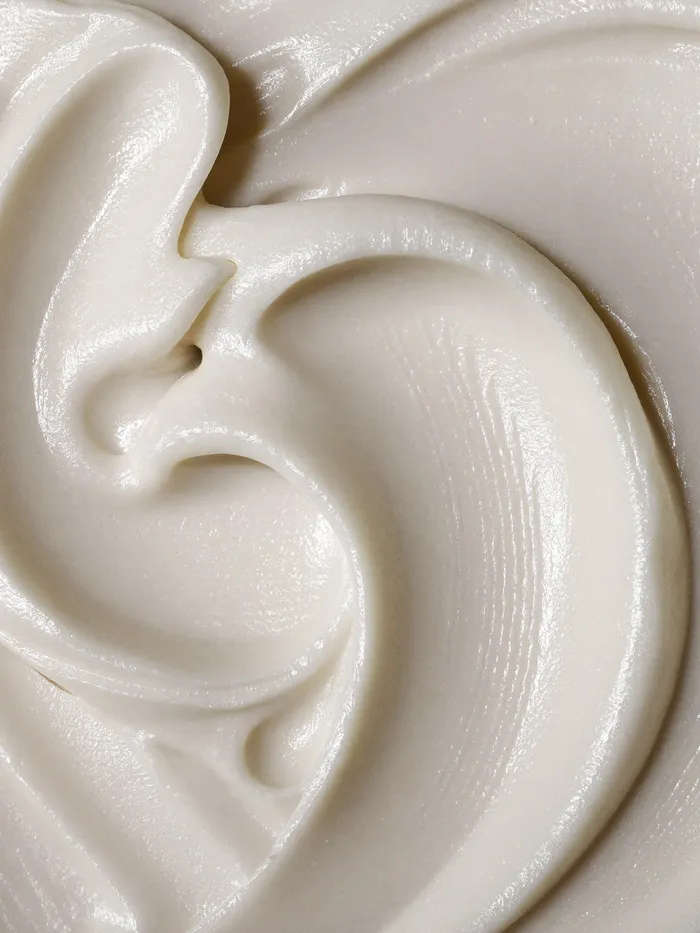 Creamy white texture swirls in luxurious beauty product