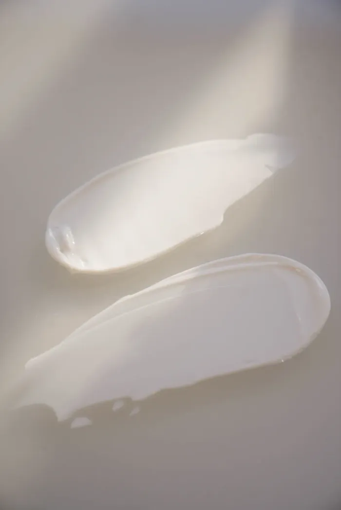 Minimalist skincare cream swatches on neutral background